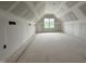 Unfinished bonus room with window offering natural light; ready for customization and use at 183 Tee Dr, Selma, NC 27576