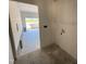 View into garage from dedicated laundry room with convenient access and ample space for appliances at 183 Tee Dr, Selma, NC 27576