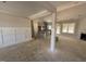 An unfinished living room featuring recessed lights, fireplace, wainscotting, with access to kitchen and outdoor patio at 183 Tee Dr, Selma, NC 27576