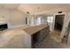 An unfinished living room featuring recessed lights, fireplace, with access to kitchen at 183 Tee Dr, Selma, NC 27576