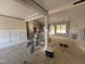 Spacious living room boasts board and batten wainscoting, a fireplace, and an open floor plan leading to the kitchen at 183 Tee Dr, Selma, NC 27576