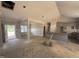 An unfinished living room featuring recessed lights, wainscotting, with access to kitchen and outdoor patio at 183 Tee Dr, Selma, NC 27576