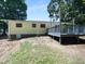 Exterior features home and partially covered deck in backyard with blue sky at 1914 Adams Pl, Hillsborough, NC 27278