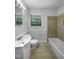 Bathroom features a white vanity, toilet, tub, and a window for natural light at 1914 Adams Pl, Hillsborough, NC 27278