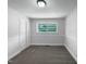 View of a bedroom with neutral walls, carpeted floors, closet, and a window for natural light at 1914 Adams Pl, Hillsborough, NC 27278