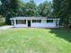 Charming single-story home with a well-maintained lawn and a cozy, inviting entrance at 1914 Adams Pl, Hillsborough, NC 27278