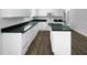 This kitchen features granite countertops, stainless steel appliances, and wood-look floors at 1914 Adams Pl, Hillsborough, NC 27278