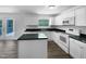 This kitchen features an island, granite countertops, stainless steel appliances, and wood-look floors at 1914 Adams Pl, Hillsborough, NC 27278