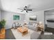 Bright, staged living room featuring a ceiling fan, neutral color scheme, and comfortable seating at 1914 Adams Pl, Hillsborough, NC 27278