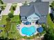 Stunning aerial view of the property, showcasing the backyard pool and lush landscaping at 205 Silent Cove Ln, Holly Springs, NC 27540