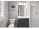 Modern bathroom featuring a toilet, vanity, and glass-enclosed shower, complete with contemporary fixtures at 205 Silent Cove Ln, Holly Springs, NC 27540