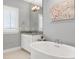 Well-lit bathroom with a soaking tub, granite countertop vanity and decorative lighting at 205 Silent Cove Ln, Holly Springs, NC 27540