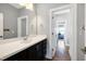 Stylish bathroom features a sleek vanity, large mirror, and modern fixtures enhancing the home's appeal at 205 Silent Cove Ln, Holly Springs, NC 27540