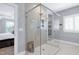 Modern bathroom features a glass shower enclosure with tile surround, custom shelving, and vanity at 205 Silent Cove Ln, Holly Springs, NC 27540