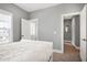 Bright bedroom with a comfortable bed, natural light, and a view to other rooms, creating a relaxing space at 205 Silent Cove Ln, Holly Springs, NC 27540