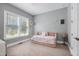 Bright bedroom featuring a stylish daybed and large windows at 205 Silent Cove Ln, Holly Springs, NC 27540