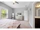 Comfortable bedroom with a full bed, dresser, and large windows providing ample natural light at 205 Silent Cove Ln, Holly Springs, NC 27540