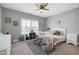 Cozy bedroom offers a ceiling fan, natural light from a window, and a comfortable atmosphere at 205 Silent Cove Ln, Holly Springs, NC 27540