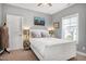 Charming bedroom with a well-lit room featuring a comfortable bed, side tables, and bright wall decor at 205 Silent Cove Ln, Holly Springs, NC 27540