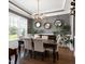 Formal dining room features hardwood floors, modern chandelier, and elegant decor at 205 Silent Cove Ln, Holly Springs, NC 27540