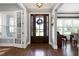 Elegant foyer with hardwood floors, a stylish front door, and ample natural light at 205 Silent Cove Ln, Holly Springs, NC 27540