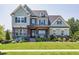 Charming two-story home with a landscaped front yard and inviting front porch at 205 Silent Cove Ln, Holly Springs, NC 27540