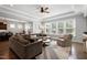 Bright and airy living room featuring tray ceilings, hardwood floors and large windows at 205 Silent Cove Ln, Holly Springs, NC 27540