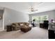 Spacious living room features a cozy sofa, exercise bike, and large windows providing natural light at 205 Silent Cove Ln, Holly Springs, NC 27540