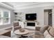 Comfortable living room with a fireplace, built-in shelving, and plush seating at 205 Silent Cove Ln, Holly Springs, NC 27540