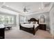 Elegant main bedroom boasts tray ceilings, large windows and a decorative ceiling fan at 205 Silent Cove Ln, Holly Springs, NC 27540