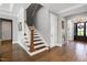 Elegant stairway featuring hardwood steps and a white banister at 205 Silent Cove Ln, Holly Springs, NC 27540