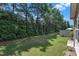 A lush backyard features trees, shrubbery, grass and is partially fenced at 211 Westgrove Ct, Durham, NC 27703