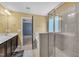 Light-filled bathroom with tile floors, shower, bathtub, double sinks and modern fixtures at 211 Westgrove Ct, Durham, NC 27703