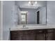 A light blue bathroom has a dark wood vanity with a white countertop and large mirror at 211 Westgrove Ct, Durham, NC 27703
