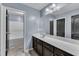 Bathroom featuring a long vanity with white countertop, modern mirror and vinyl floors at 211 Westgrove Ct, Durham, NC 27703