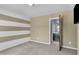 Bedroom with ensuite bathroom with neutral paint, carpet and a striped accent wall at 211 Westgrove Ct, Durham, NC 27703