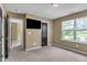 Neutral bedroom with a ceiling fan, carpet floors, and bright window at 211 Westgrove Ct, Durham, NC 27703