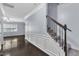 Inviting entryway featuring dark hardwood floors and an elegant staircase with wrought iron details at 211 Westgrove Ct, Durham, NC 27703