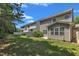 The backyard of the townhome shows well-manicured lawn and shrubbery with partial fencing at 211 Westgrove Ct, Durham, NC 27703