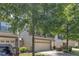 Home exterior showing stone accents, a two-car garage, and well-maintained landscaping at 211 Westgrove Ct, Durham, NC 27703