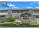 Rear exterior of townhome showcasing a well-kept lawn and patio area at 211 Westgrove Ct, Durham, NC 27703