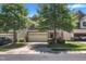 Charming home with a two-car garage, stone accents, a well-manicured lawn, and mature trees at 211 Westgrove Ct, Durham, NC 27703