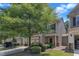 Home featuring a two-car garage, stone accents, and well-manicured landscaping at 211 Westgrove Ct, Durham, NC 27703