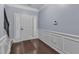 Welcoming foyer with a front door, wainscoting, and hardwood flooring at 211 Westgrove Ct, Durham, NC 27703
