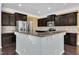 The kitchen showcases granite countertops, dark cabinets, stainless steel appliances, and a breakfast bar at 211 Westgrove Ct, Durham, NC 27703