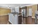 A kitchen showcases dark wood floors, granite countertops, stainless steel appliances, and bar seating at 211 Westgrove Ct, Durham, NC 27703