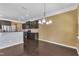 A kitchen and dining area, complete with dark cabinets and stainless steel appliances at 211 Westgrove Ct, Durham, NC 27703