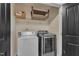A laundry room is equipped with modern machines, ample storage, and a functional design at 211 Westgrove Ct, Durham, NC 27703
