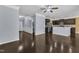 Spacious living room with hardwood floors opens to the kitchen with a breakfast bar at 211 Westgrove Ct, Durham, NC 27703