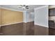 Open-concept living room with hardwood floors and a ceiling fan, connected to the kitchen area at 211 Westgrove Ct, Durham, NC 27703